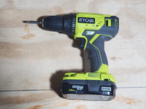 Ryobi Drill with 1.5 Amp Hour 18 volt Lithium Ion Battery lying on a work bench